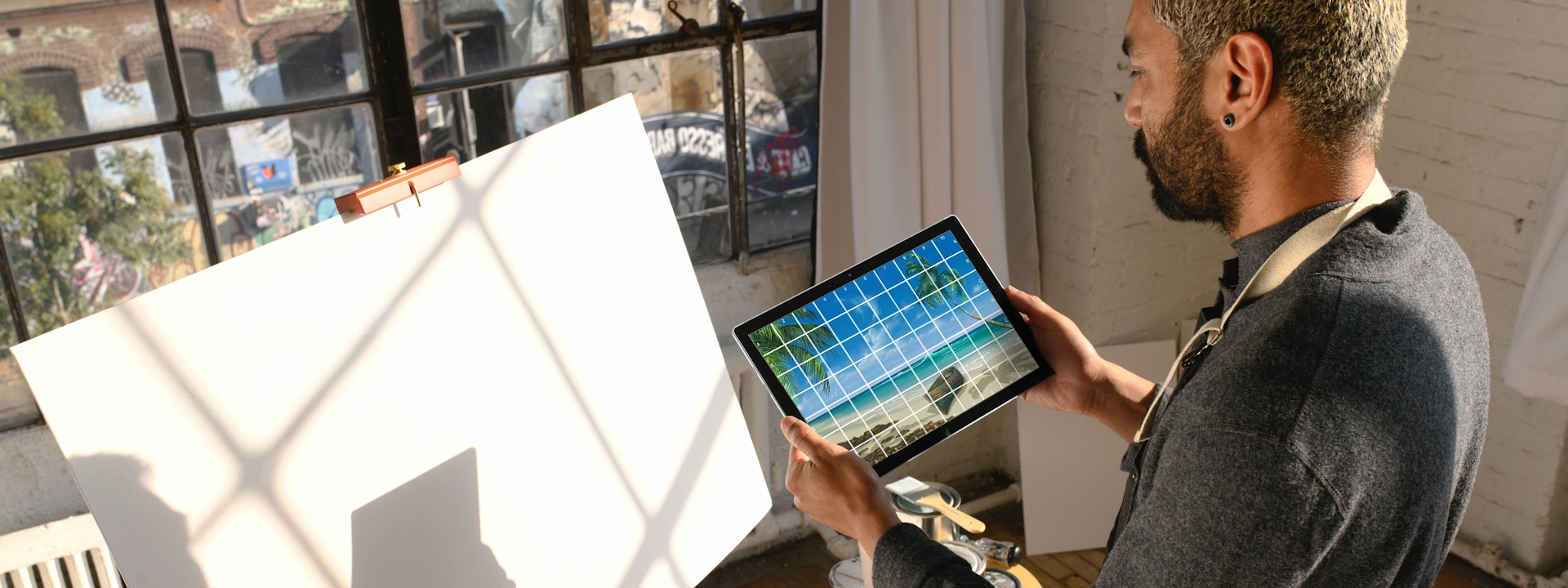 painter using grid to transform reference photo
