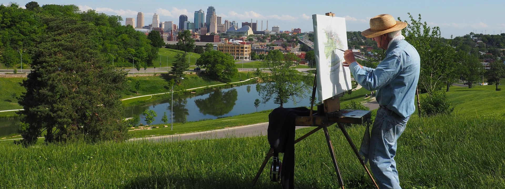 painter painting landscape artwork in nature on easel